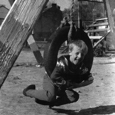 Young boy playing on a swing. 1980s | Photo: Our Broomhall